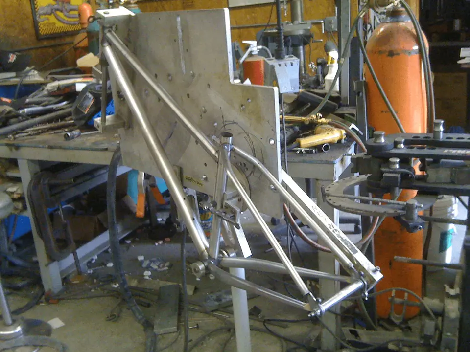 A Jay The Hill mountain bike frame in the fabrication jig in our founder’s workshop